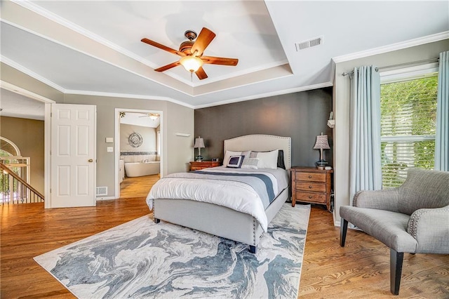 7905 W 129th St, Overland Park, KS 66213 - bedroom with a raised ceiling, wood finished floors, ensuite bathroom, ornamental molding, and a ceiling fan