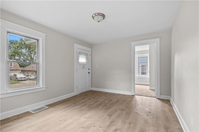 2100 S Scott Ave, Independence, MO 64052 - foyer entrance with light wood finished floors and baseboards