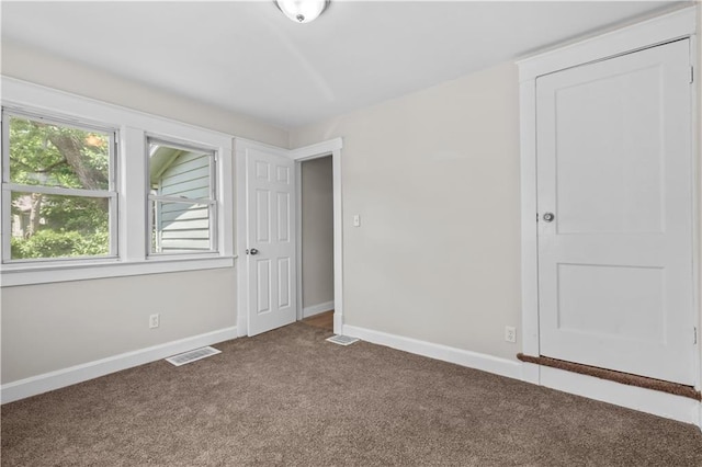 2100 S Scott Ave, Independence, MO 64052 - unfurnished bedroom featuring carpet flooring and baseboards