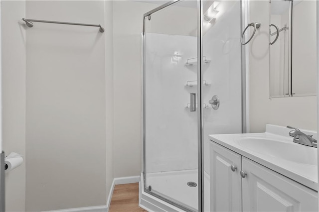 2100 S Scott Ave, Independence, MO 64052 - full bathroom with vanity, a shower stall, and wood finished floors