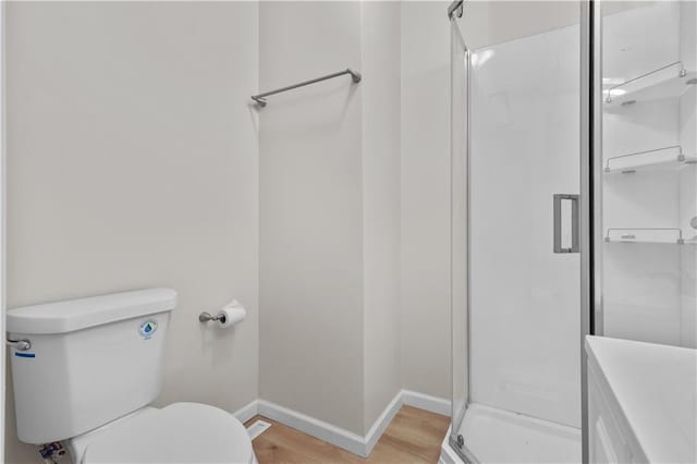2100 S Scott Ave, Independence, MO 64052 - bathroom featuring toilet, baseboards, a stall shower, and wood finished floors