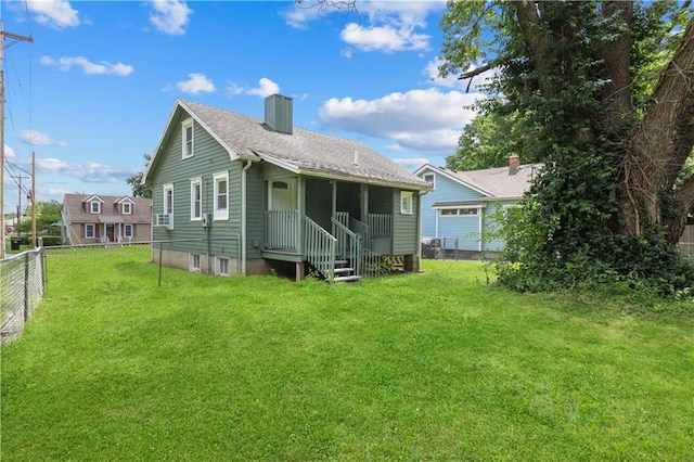 2100 S Scott Ave, Independence, MO 64052 - back of house with a chimney and a shingled roof