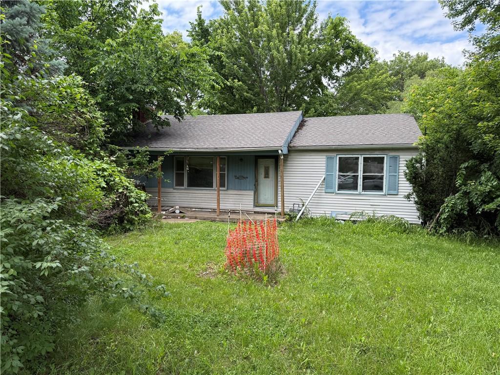 8620 W 75th St, Overland Park, KS 66204 - view of front of house featuring a front lawn and roof with shingles