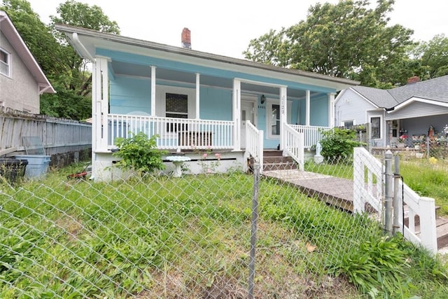 1129 Metropolitan Ave, Kansas City, KS 66103 - bungalow with a porch and a chimney
