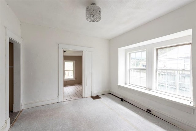 1129 Metropolitan Ave, Kansas City, KS 66103 - empty room featuring tile patterned floors and baseboards