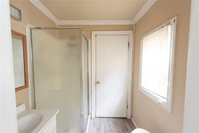 1129 Metropolitan Ave, Kansas City, KS 66103 - full bath with vanity, a shower stall, wood finished floors, and crown molding
