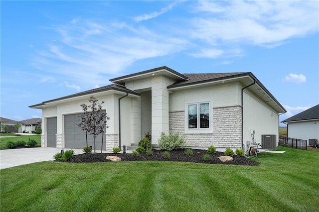 9412 Aurora St, Lenexa, KS 66220 - view of front of home featuring a garage, driveway, a front lawn, and central AC unit