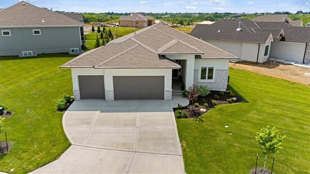 9412 Aurora St, Lenexa, KS 66220 - view of front of house with an attached garage, concrete driveway, and a front lawn