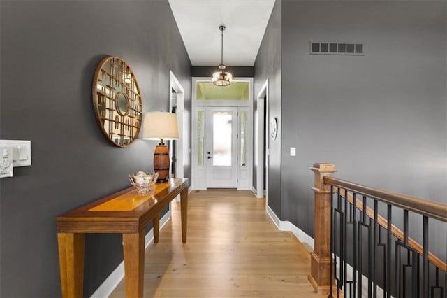 9412 Aurora St, Lenexa, KS 66220 - entrance foyer with light wood-style flooring, a chandelier, and baseboards