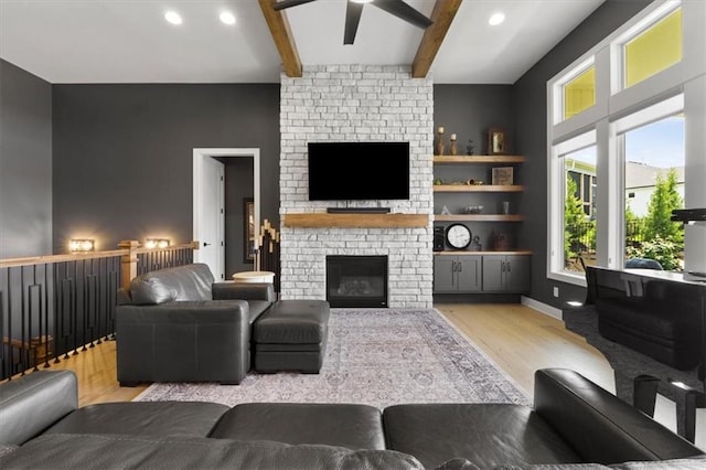 9412 Aurora St, Lenexa, KS 66220 - living area featuring light wood-type flooring, a brick fireplace, beam ceiling, ceiling fan, and recessed lighting