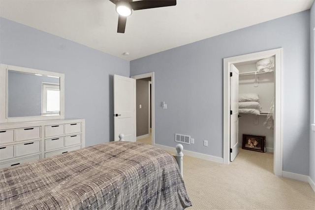 9412 Aurora St, Lenexa, KS 66220 - bedroom featuring baseboards, light colored carpet, a spacious closet, a ceiling fan, and a closet