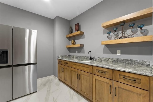 9412 Aurora St, Lenexa, KS 66220 - bar with stainless steel fridge with ice dispenser, light marble finish floors, a sink, and baseboards