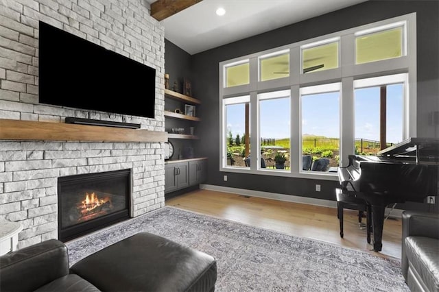 9412 Aurora St, Lenexa, KS 66220 - living room featuring a brick fireplace, wood finished floors, baseboards, built in shelves, and recessed lighting