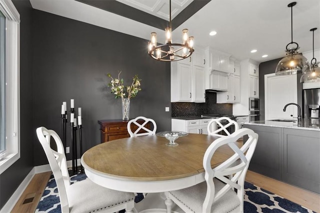 9412 Aurora St, Lenexa, KS 66220 - dining area with light wood-style floors, recessed lighting, a chandelier, and baseboards