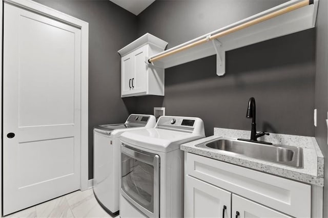 9412 Aurora St, Lenexa, KS 66220 - laundry room with washer and dryer, cabinet space, and light marble finish floors