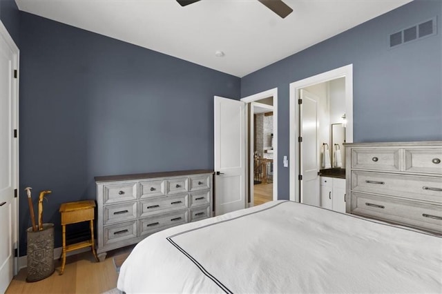 9412 Aurora St, Lenexa, KS 66220 - bedroom with light wood-type flooring, ensuite bath, a ceiling fan, and baseboards