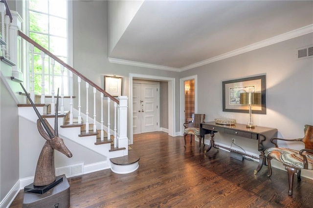 1055 W 54th St, Kansas City, MO 64112 - entrance foyer with wood finished floors, stairway, and crown molding