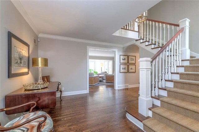 1055 W 54th St, Kansas City, MO 64112 - foyer entrance featuring wood finished floors, crown molding, and stairway