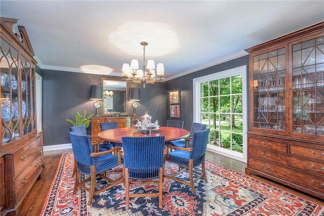 1055 W 54th St, Kansas City, MO 64112 - dining room with a chandelier, wood finished floors, and crown molding