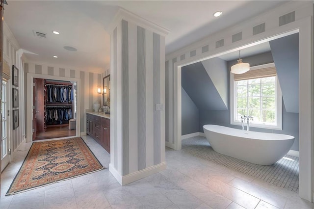 1055 W 54th St, Kansas City, MO 64112 - bathroom featuring wallpapered walls, a soaking tub, vanity, a spacious closet, and recessed lighting