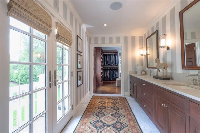 1055 W 54th St, Kansas City, MO 64112 - full bathroom with double vanity, crown molding, french doors, and a walk in closet