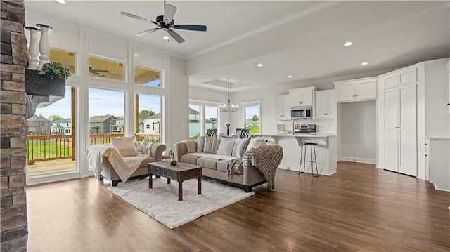1300 Melissa Ct, Kearney, MO 64060 - living area featuring dark wood-style floors, ornamental molding, ceiling fan, recessed lighting, and a chandelier