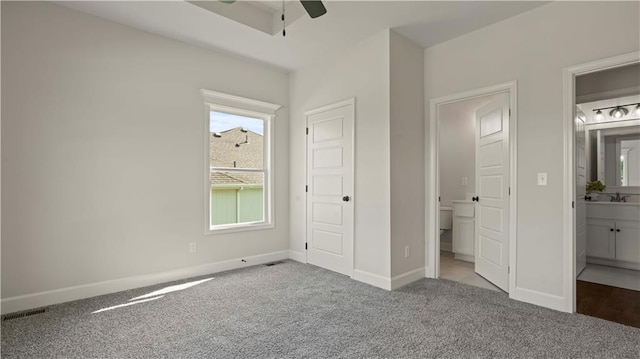1300 Melissa Ct, Kearney, MO 64060 - unfurnished bedroom with carpet, baseboards, connected bathroom, a sink, and a ceiling fan