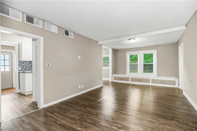 9318 Noland Rd, Lenexa, KS 66215 - empty room featuring wood finished floors, plenty of natural light, and baseboards