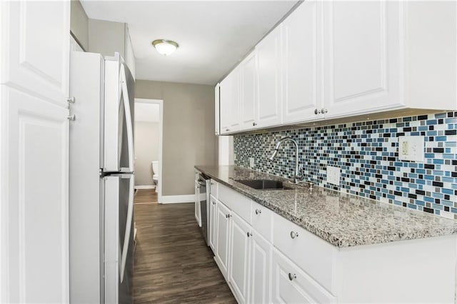 9318 Noland Rd, Lenexa, KS 66215 - kitchen featuring freestanding refrigerator, a sink, baseboards, tasteful backsplash, and dark wood-type flooring
