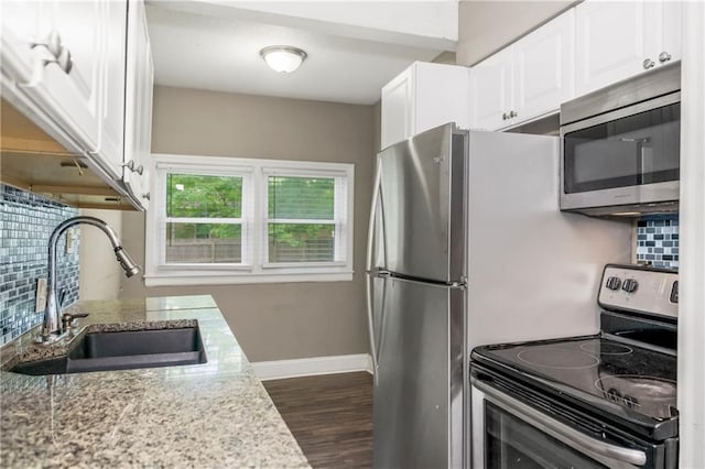 9318 Noland Rd, Lenexa, KS 66215 - kitchen featuring stainless steel appliances, a sink, tasteful backsplash, white cabinetry, and dark wood-style flooring