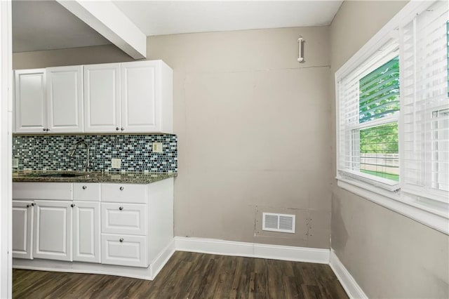 9318 Noland Rd, Lenexa, KS 66215 - kitchen featuring a sink, white cabinets, dark wood-style floors, tasteful backsplash, and baseboards