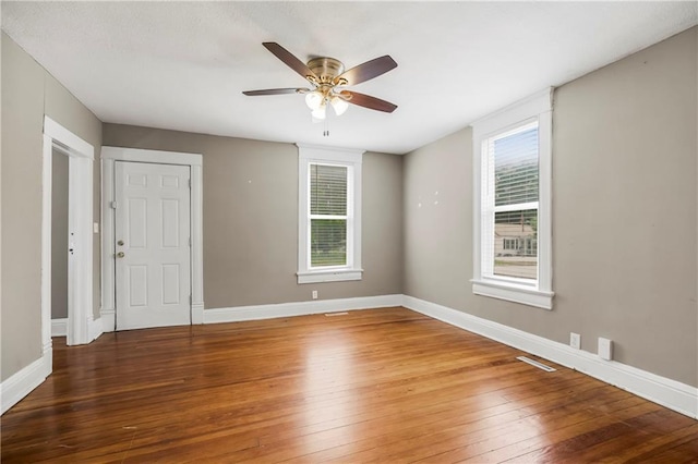 9318 Noland Rd, Lenexa, KS 66215 - unfurnished room featuring hardwood / wood-style flooring, ceiling fan, and baseboards