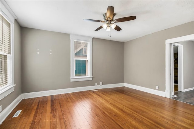 9318 Noland Rd, Lenexa, KS 66215 - spare room with hardwood / wood-style floors, ceiling fan, and baseboards