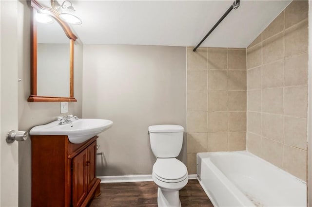 9318 Noland Rd, Lenexa, KS 66215 - full bath featuring vanity, toilet, wood finished floors, baseboards, and shower / tub combination