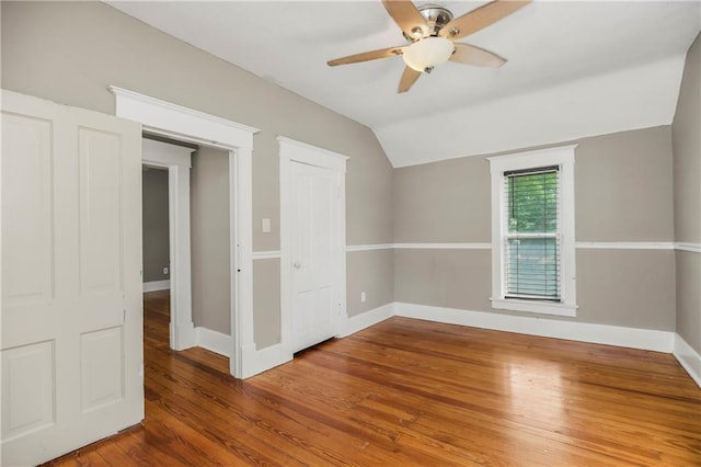 9318 Noland Rd, Lenexa, KS 66215 - unfurnished bedroom with vaulted ceiling, baseboards, wood finished floors, and a ceiling fan