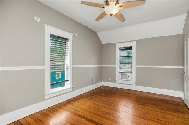 9318 Noland Rd, Lenexa, KS 66215 - spare room with lofted ceiling, hardwood / wood-style floors, healthy amount of natural light, and baseboards
