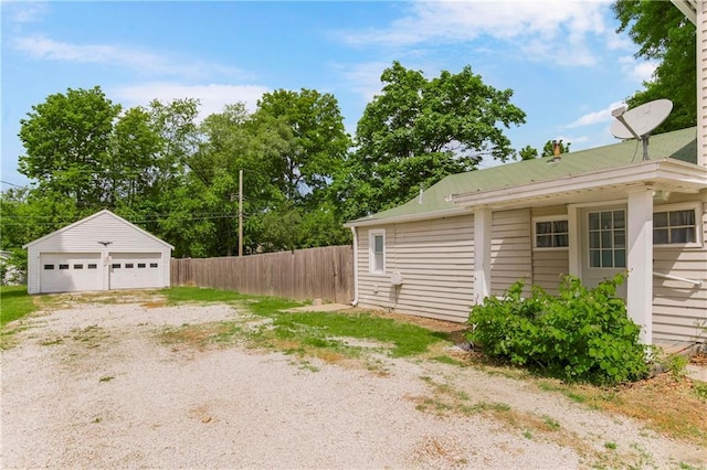 9318 Noland Rd, Lenexa, KS 66215 - view of home's exterior with a detached garage and an outdoor structure