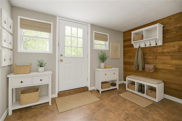 9318 Noland Rd, Lenexa, KS 66215 - mudroom featuring healthy amount of natural light and wood walls