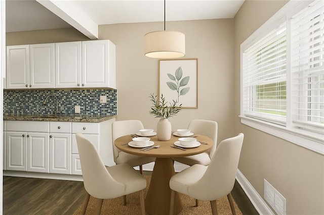 9318 Noland Rd, Lenexa, KS 66215 - dining space with dark wood-style flooring and beam ceiling