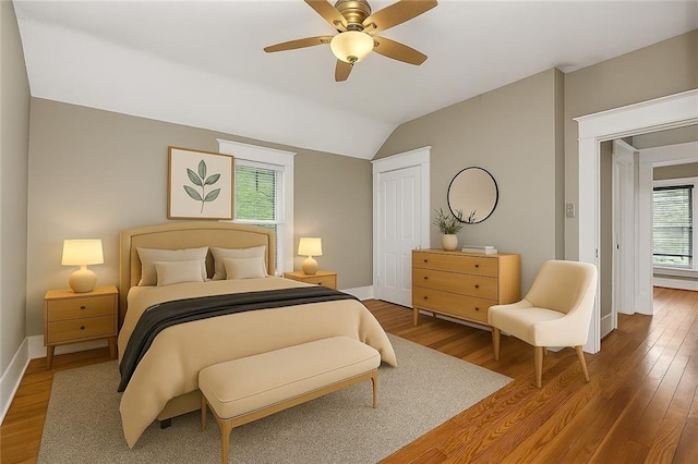 9318 Noland Rd, Lenexa, KS 66215 - bedroom with wood finished floors, lofted ceiling, a closet, and ceiling fan