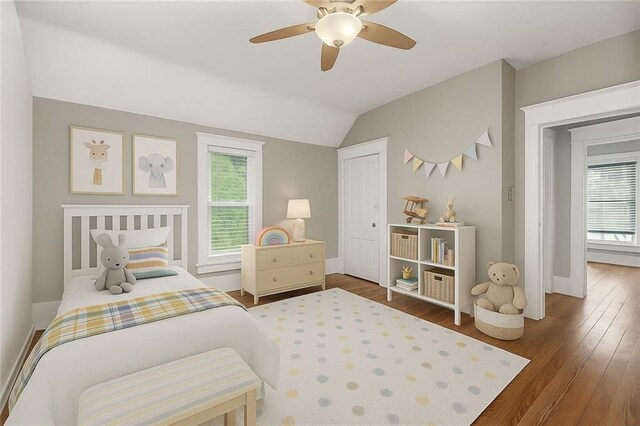 9318 Noland Rd, Lenexa, KS 66215 - bedroom with multiple windows, wood finished floors, lofted ceiling, and a ceiling fan