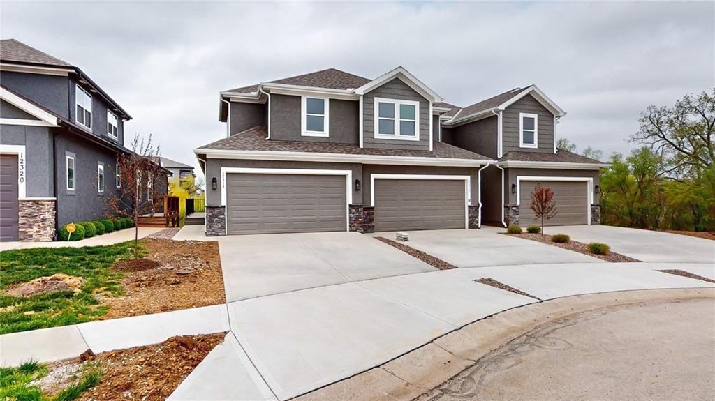 12316 S Prairie Creek Rd, Olathe, KS 66061 - craftsman inspired home with stone siding, concrete driveway, and an attached garage