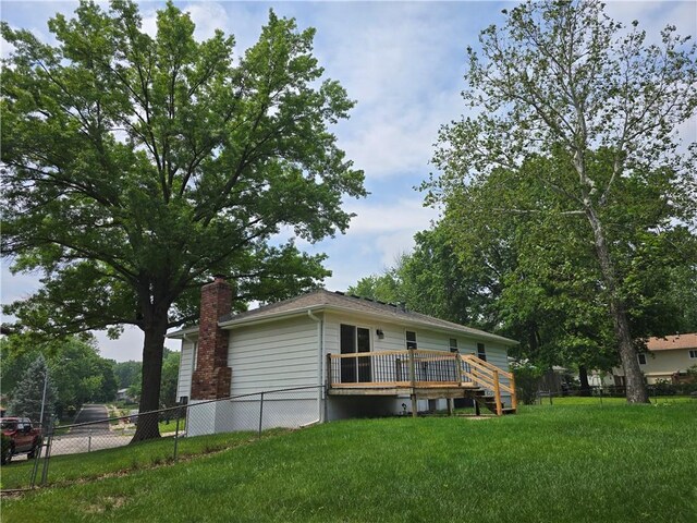 1506 N Holland Ct, Independence, MO 64056 - back of property featuring a wooden deck and a chimney