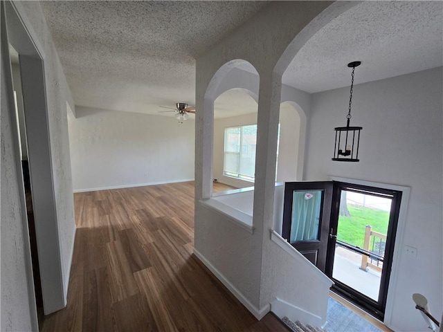 1506 N Holland Ct, Independence, MO 64056 - foyer featuring a textured ceiling, wood finished floors, arched walkways, and ceiling fan