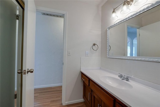 1506 N Holland Ct, Independence, MO 64056 - bathroom featuring vanity, wood finished floors, and decorative backsplash
