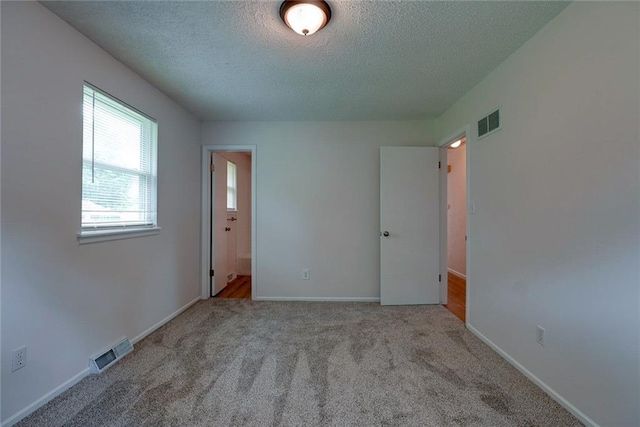 1506 N Holland Ct, Independence, MO 64056 - carpeted spare room with a textured ceiling and baseboards