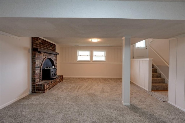 1506 N Holland Ct, Independence, MO 64056 - basement featuring a wood stove, carpet, and stairs
