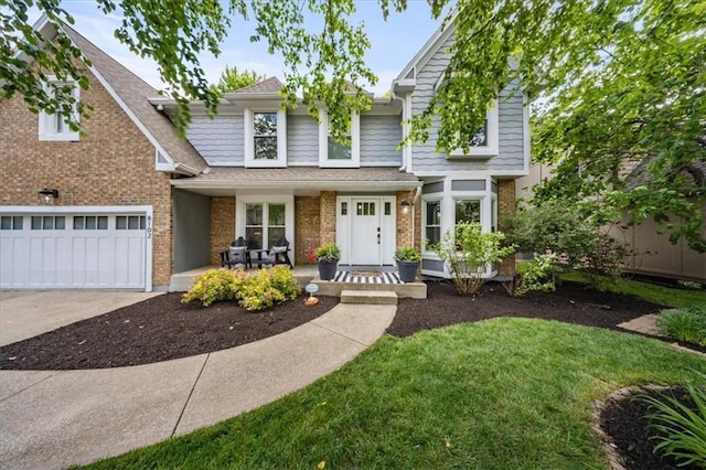 8102 W 153rd St, Overland Park, KS 66223 - view of front of home with brick siding, driveway, and covered porch