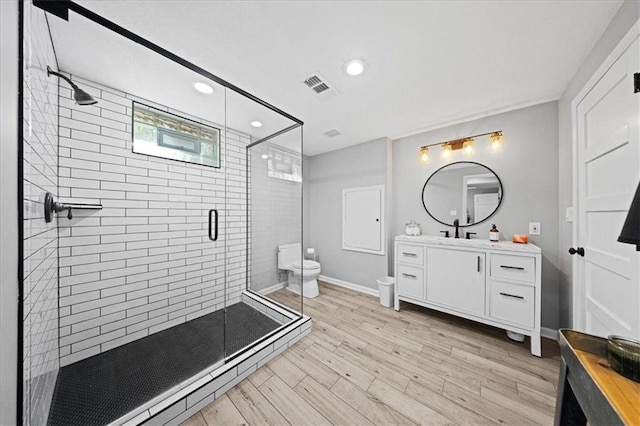 8102 W 153rd St, Overland Park, KS 66223 - full bath with vanity, toilet, a shower stall, recessed lighting, and wood finished floors