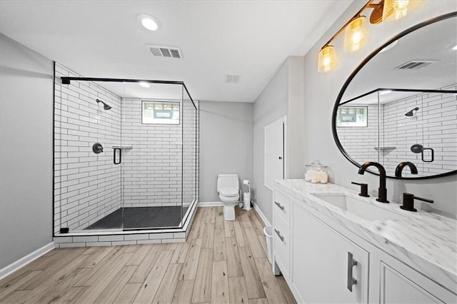 8102 W 153rd St, Overland Park, KS 66223 - full bathroom with vanity, toilet, a shower stall, wood finished floors, and recessed lighting